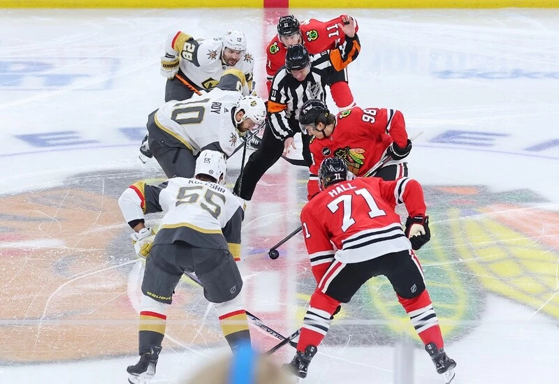 Nicolas Roy #10 of the Vegas Golden Knights and Connor Bedard #98 of the Chicago Blackhawks face-off to open the game at the United Center on October 21, 2023 in Chicago, Illinois. The Blackhawks vs Golden Knights Odds are set.