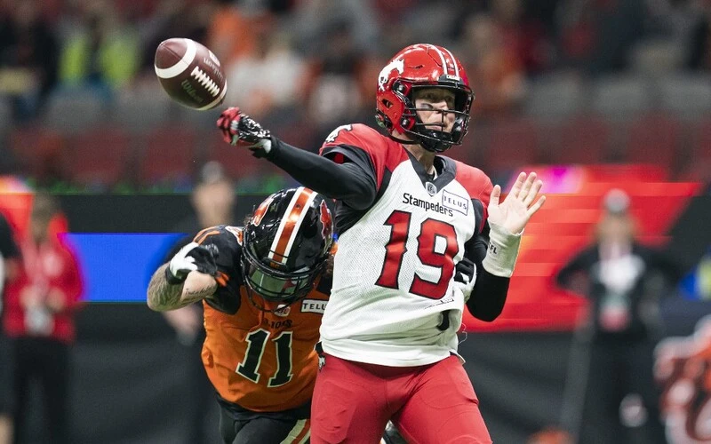 Anthony Cioffi #11 of the BC Lions hits the arm of quarterback Bo Levi Mitchell #19 of the Calgary Stampeders during a pass attempt during the second half of CFL football action at BC Place on October 16, 2021 in Vancouver, British Columbia, Canada. The Blue Bombers vs Stampeders Betting is about to start.