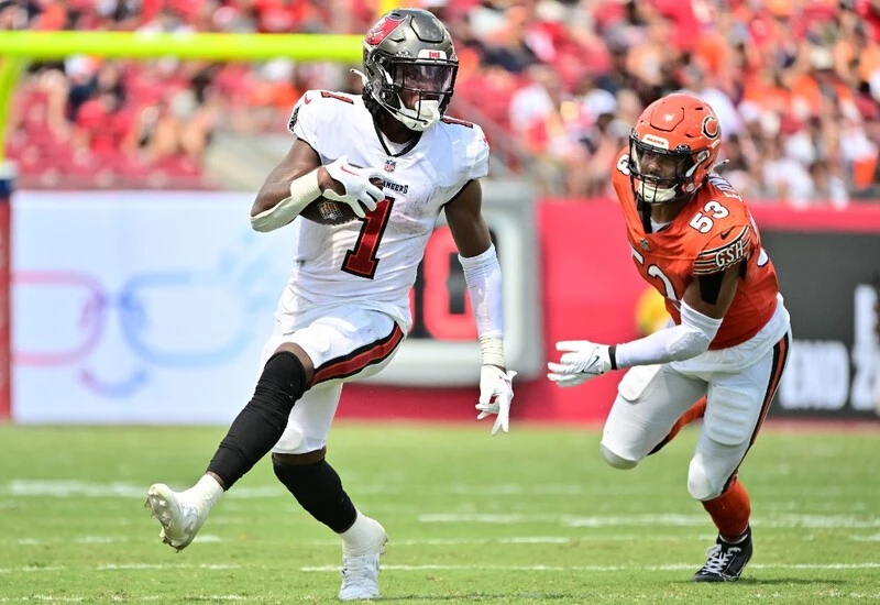 Rachaad White #1 of the Tampa Bay Buccaneers runs past T.J. Edwards #53 of the Chicago Bears during the third quarter at Raymond James Stadium on September 17, 2023 in Tampa, Florida. The Buccaneers vs Bills Odds are ready for Thursday's game.