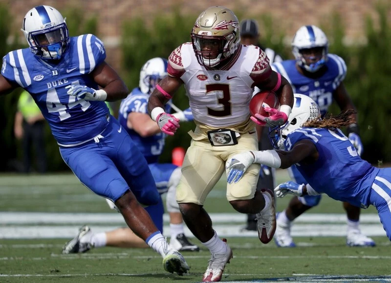 Jeremy McDuffie #9 of the Duke Blue Devils tries to stop Cam Akers #3 of the Florida State Seminoles during their game at Wallace Wade Stadium on October 14, 2017. The Duke vs Florida State Odds for this game are available.