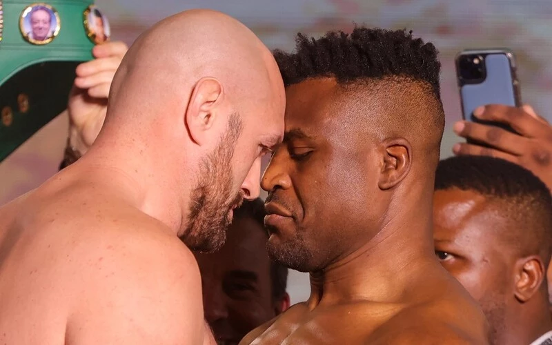 Britain's Tyson Fury (L) and Cameroonian-French Francis Ngannou go head to head during their weigh-in on the eve of their bout in Riyadh on October 27, 2023. The Fury vs Ngannou Prediction is here.