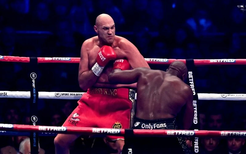 Britain's Tyson Fury fights against Britain's Derek Chisora during their WBC heavyweight title boxing match, at the Tottenham Hotspur stadium in east London, on December 3, 2022. The Fury vs Ngannou Prediction is here.