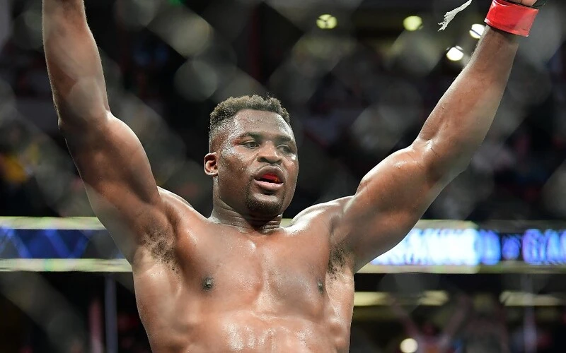 UFC 270 heavyweight world champion Cameroon's Francis Ngannou celebrates victory over France's Ciryl Gane after their fight for the heavyweight title at the Honda Center in Anaheim, California on January 22, 2022. The Fury vs Ngannou Prediction is here.