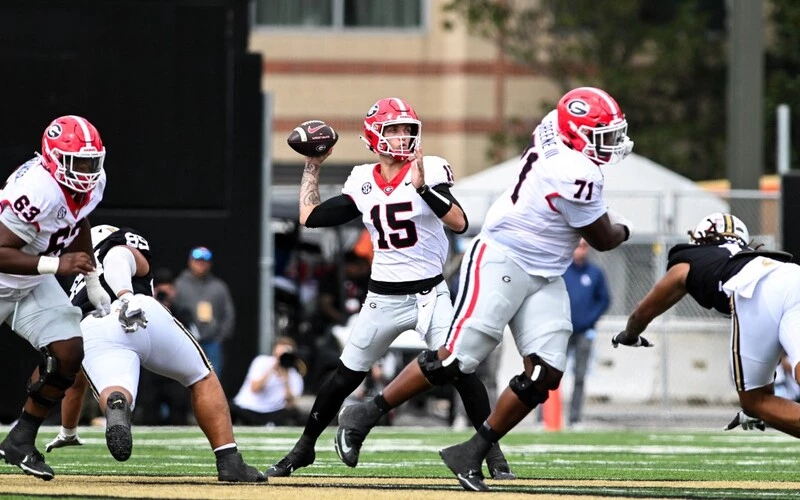 Carson Beck #15 of the Georgia Bulldogs passes the ball against the Vanderbilt Commodores in the second half at FirstBank Stadium on October 14, 2023 in Nashville, Tennessee. The Georgia vs Florida Odds are warming up for this important game.
