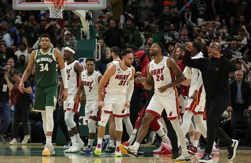Max Strus #31 and members of the Miami Heat celebrate in front of Giannis Antetokounmpo #34 of the Milwaukee Bucks after winning Game 5 of the Eastern Conference First Round Playoffs in overtime at Fiserv Forum on April 26, 2023 in Milwaukee, Wisconsin. The Heat vs Bucks Odds are already set for tonight's game.
