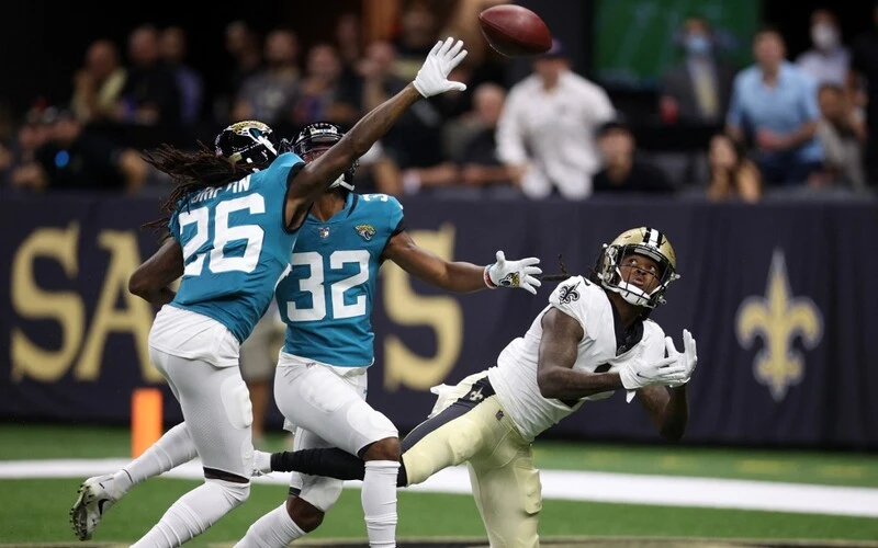 Marquez Callaway #1 of the New Orleans Saints catches a pass for a touchdown over Tyson Campbell #32 of the Jacksonville Jaguars.
