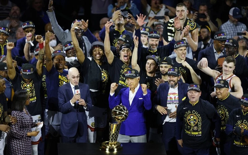 The Denver Nuggets celebrate with the Larry O'Brien Championship Trophy after a 94-89 victory against the Miami Heat in Game Five of the 2023 NBA Finals to win the NBA Championship. The NBA Season starts with the Lakers vs Nuggets Betting Odds.