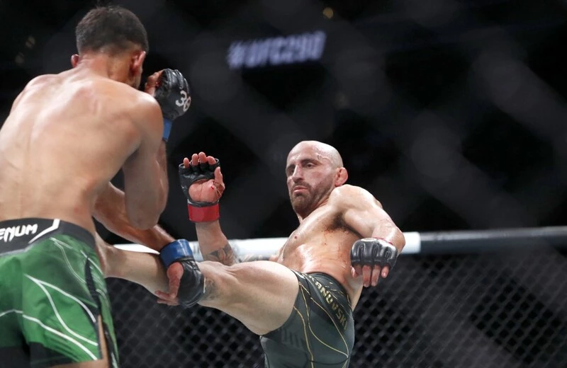 UFC featherweight champion Alexander Volkanovski (R) kicks interim featherweight champion Yair Rodriguez during UFC 290. The Makhachev vs Volkanovski prediction fight is close.
