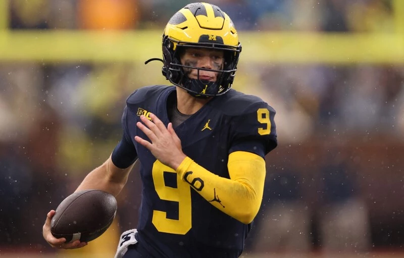 J.J. McCarthy #9 of the Michigan Wolverines plays against the Indiana Hoosiers at Michigan Stadium on October 14, 2023. The Michigan vs Michigan State Betting Odds are set.