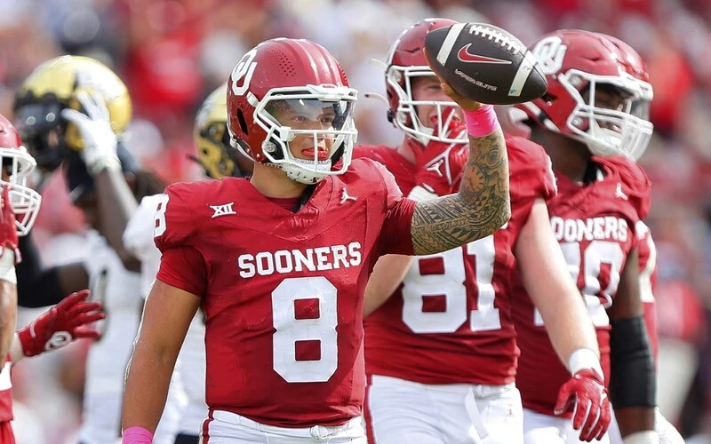 Quarterback Dillon Gabriel #8 of the Oklahoma Sooners holds up the ball as the clock runs out against the UCF Knights in the fourth quarter at Gaylord Family Oklahoma Memorial Stadium on October 21, 2023 in Norman, Oklahoma. Oklahoma won 31-29. The Oklahoma vs Kansas Odds are set.