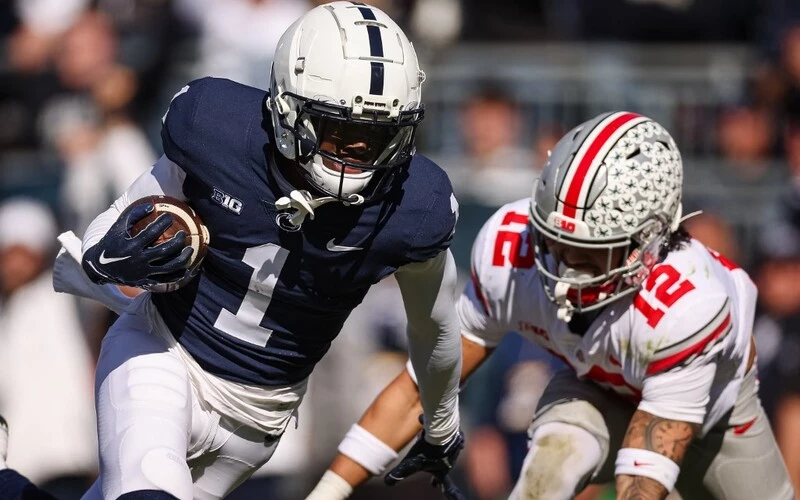 KeAndre Lambert-Smith #1 of the Penn State Nittany Lions runs for a touchdown against Lathan Ransom #12 of the Ohio State Buckeyes. The Penn State vs Ohio State Odds are already set for this exciting matchup.