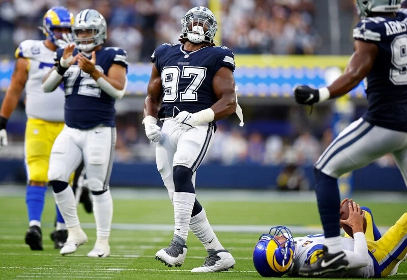 Osa Odighizuwa #97 of the Dallas Cowboys reacts after sacking Matthew Stafford #9 of the Los Angeles Rams during the fourth quarter at SoFi Stadium on October 09, 2022 in Inglewood, California. The Rams vs Cowboys betting odds are set.