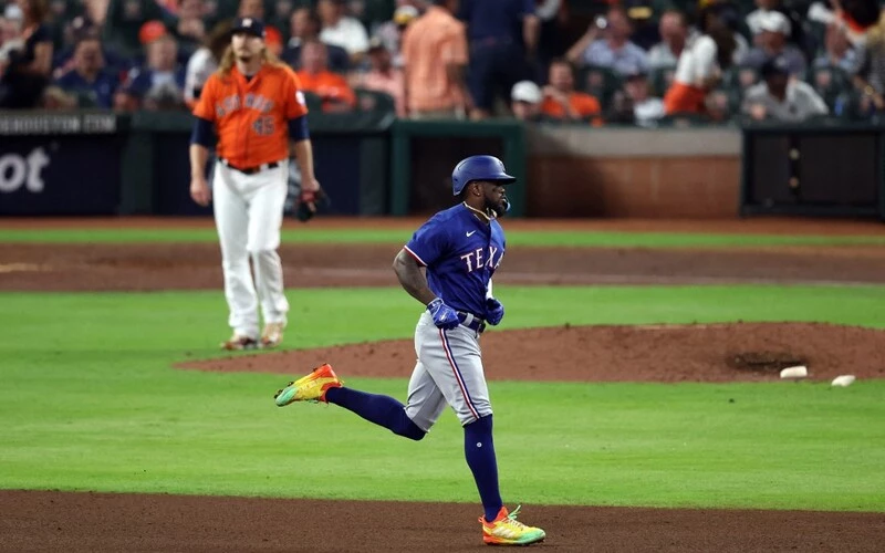 Adolis Garcia #53 of the Texas Rangers rounds the bases after hitting a grand slam home run against Ryne Stanek #45 of the Houston Astros during the ninth inning in Game Six of the American League Championship Series at Minute Maid Park on October 22, 2023 in Houston, Texas. The Rangers vs Astros Odds are ready to analyze.