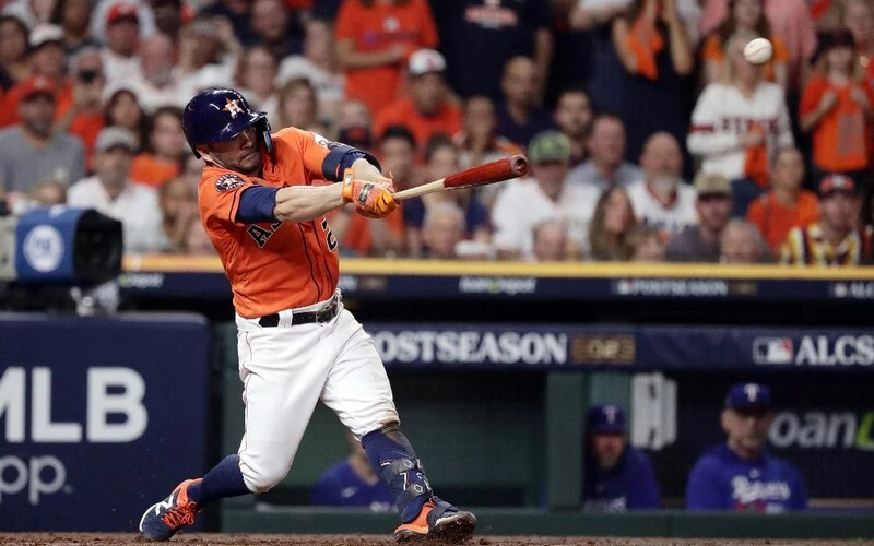 Jose Altuve #27 of the Houston Astros hits a single against Nathan Eovaldi #17 of the Texas Rangers during the seventh inning in Game Six of the American League Championship Series at Minute Maid Park on October 22, 2023 in Houston, Texas. The Rangers vs Astros Odds are ready to analyze.