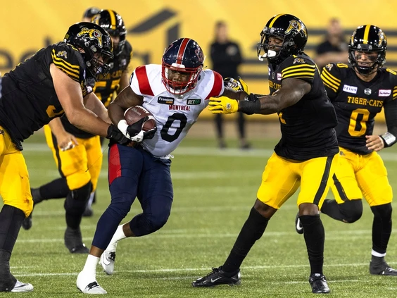 Alouettes rush-end Shawn Lemon (0) carries the ball following an interception during second half CFL football game action against the Tiger-Cats in Hamilton on Saturday, Aug. 5, 2023. The Tiger-Cats vs Alouettes betting odds for this game are truly interesting for analyze.