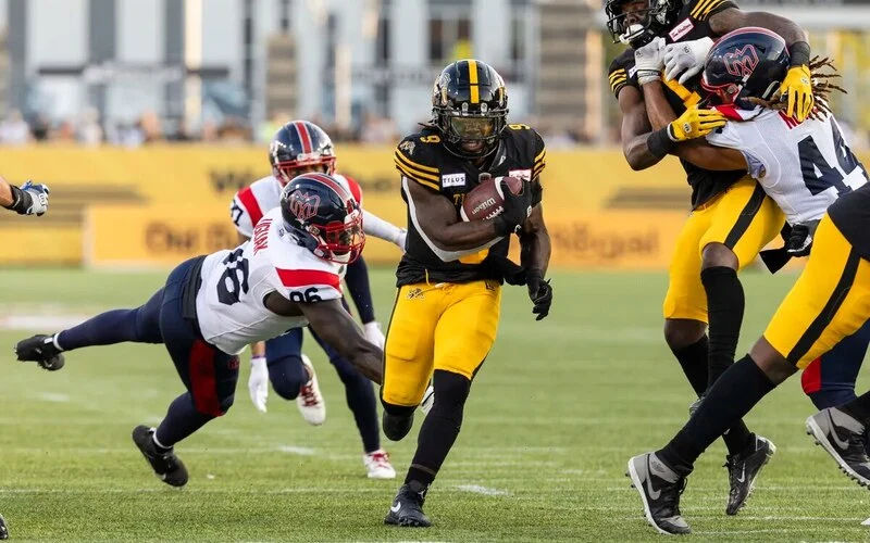 Hamilton Tiger-Cats running back James Butler (9) runs in a touchdown during CFL football game action against the Montreal Alouettes in Hamilton, Ont. on Saturday, August 5, 2023. The Tiger-Cats vs Alouettes betting odds for this game are truly interesting for analyze.