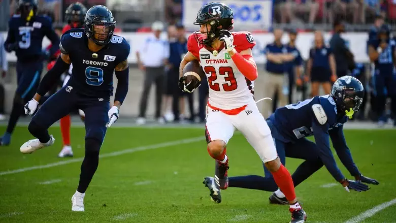 Ottawa's Jaelon Acklin runs over the Toronto Argonauts defensive line. The Argonauts vs Redblacks Betting Odds are set.